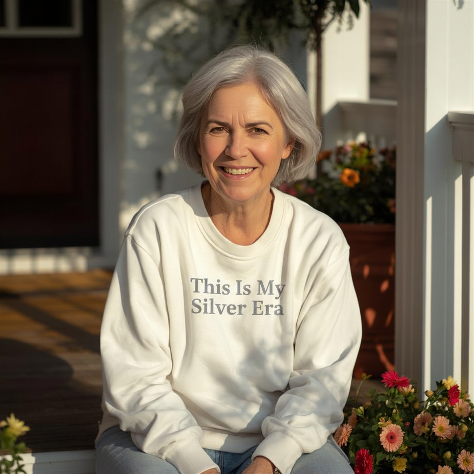 Woman with silver hair wearing a This Is My Silver Era crewneck sweatshirt